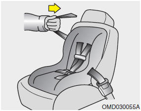 4. Slowly allow the shoulder portion of the seat belt to retract and listen for