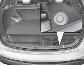 Your spare tire is stored underneath your vehicle, directly below the cargo area.