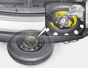 5. After the spare tire reaches the ground, continue to turn the wrench counterclockwise,